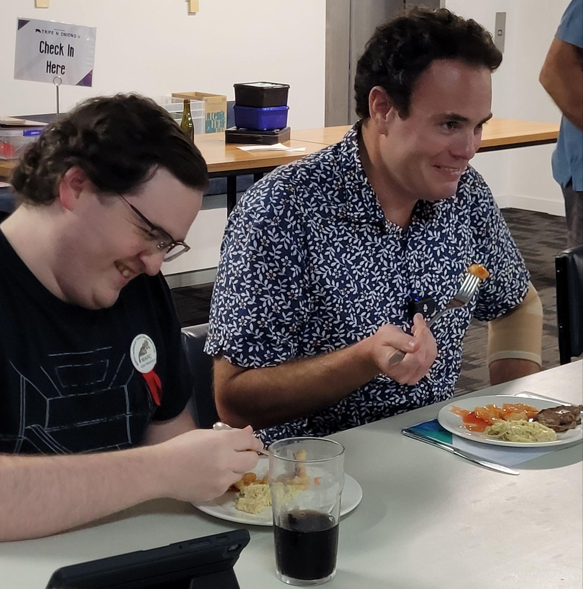 Stuff reporter Lloyd Burr and club vice-president Marc Anderson trying tripe at a club dinner
